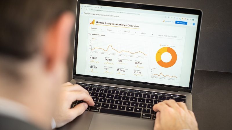 Marketer reviewing website analytics on a laptop